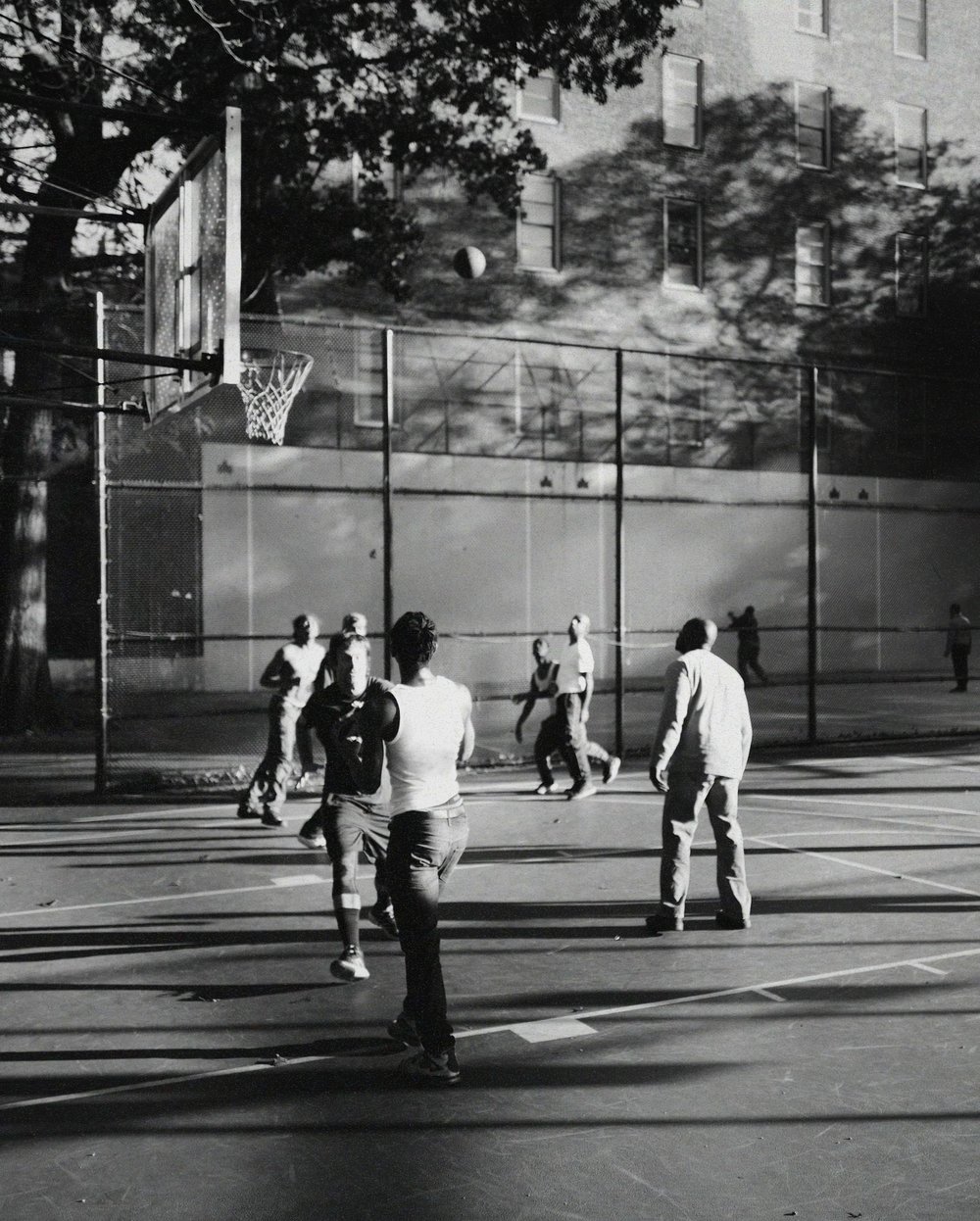 A group of people playing basketball